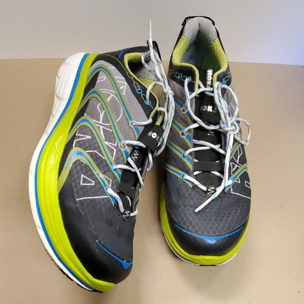 Black/grey Hoka One running shoes.